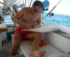 Steve repairs a sail enroute to the Marquesas