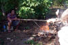 Big stick, small pig.  The Tongan feast is prepared.
